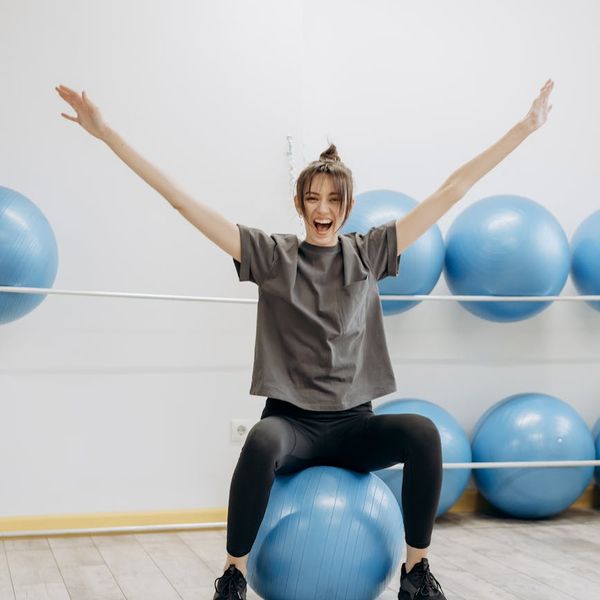 Woman feeling energetic and balanced during a light exercise routine.